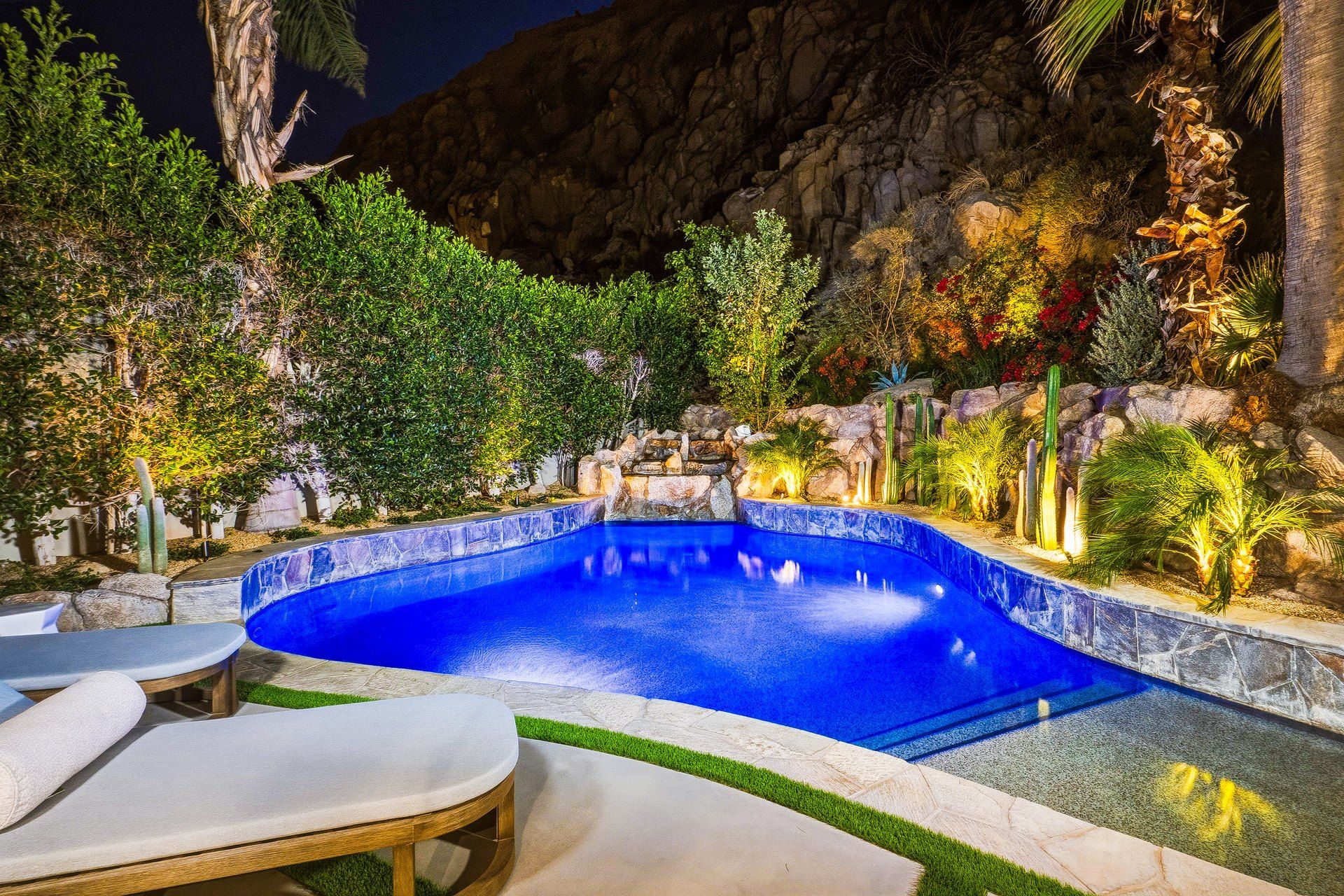 Desert-modern home at 77013 Desi Dr, Indian Wells — photographed for The Chavez Team at The Agency — pool lit at twilight beneath the hillside