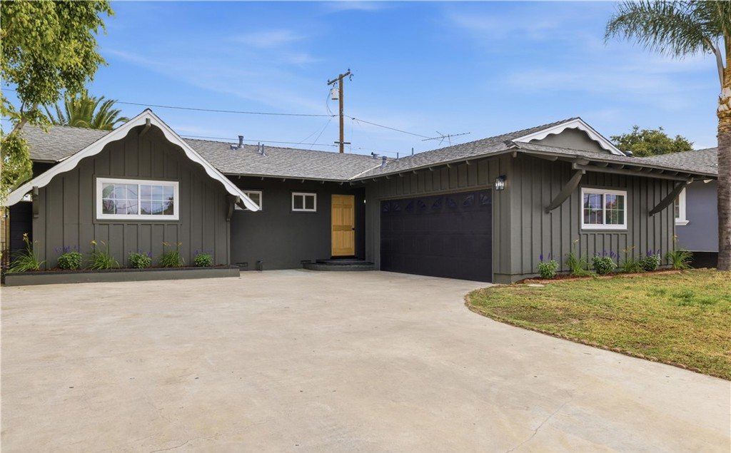 Single-story ranch home with board-and-batten siding and a wide driveway in Anaheim, California