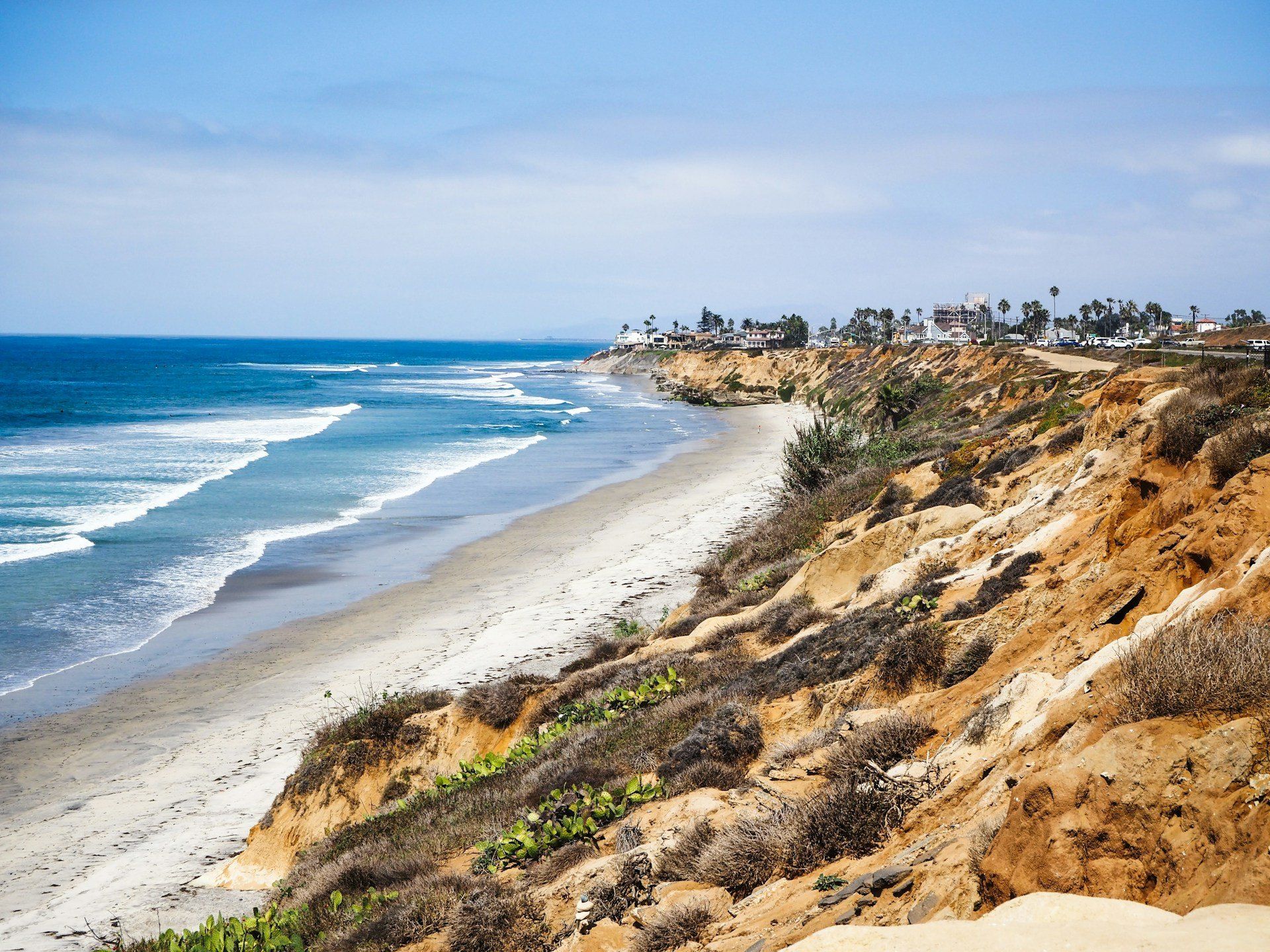 Beach and ocean seen from a bluff looking north along the coast in Carlsbad, California