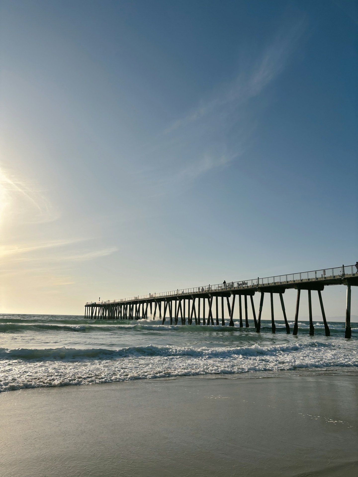 The Hermosa Beach pier extending over a calm ocean in Hermosa Beach, California