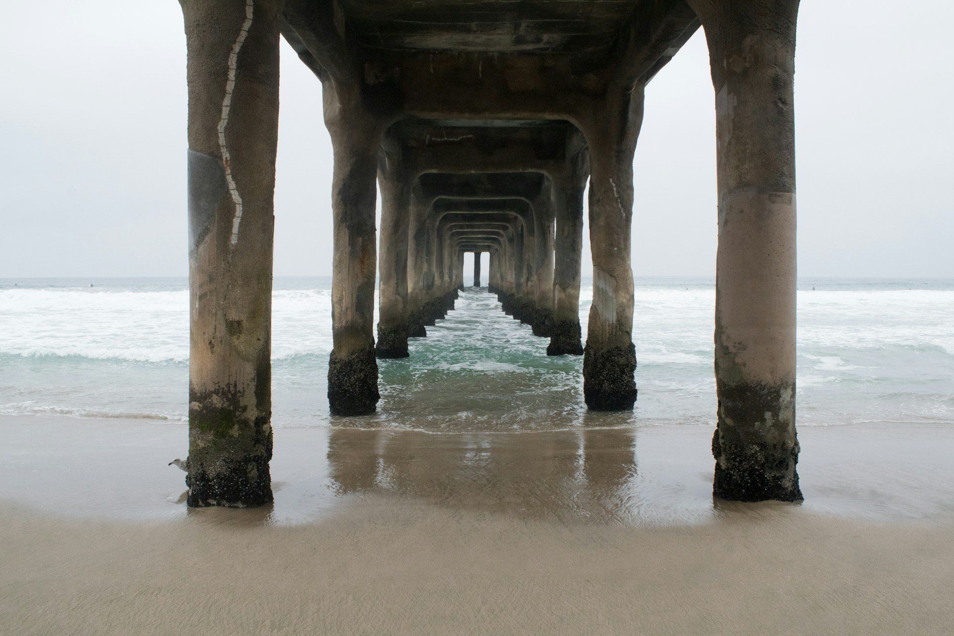 The Manhattan Beach Pier and its round end building over the ocean in Manhattan Beach, California