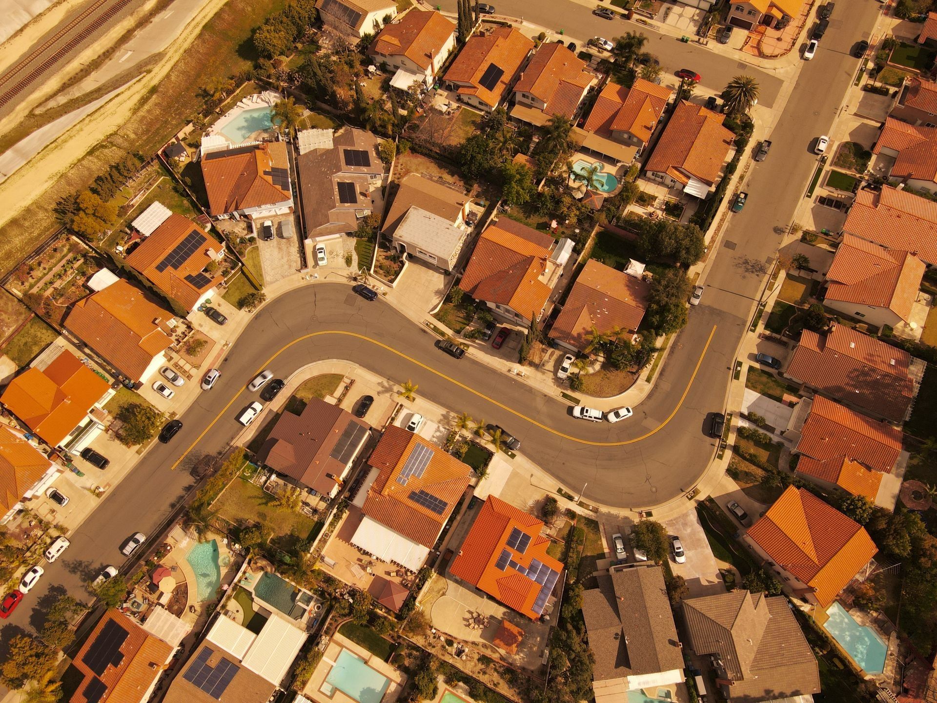 Aerial view of curved residential streets and rooftops in Mission Viejo, California