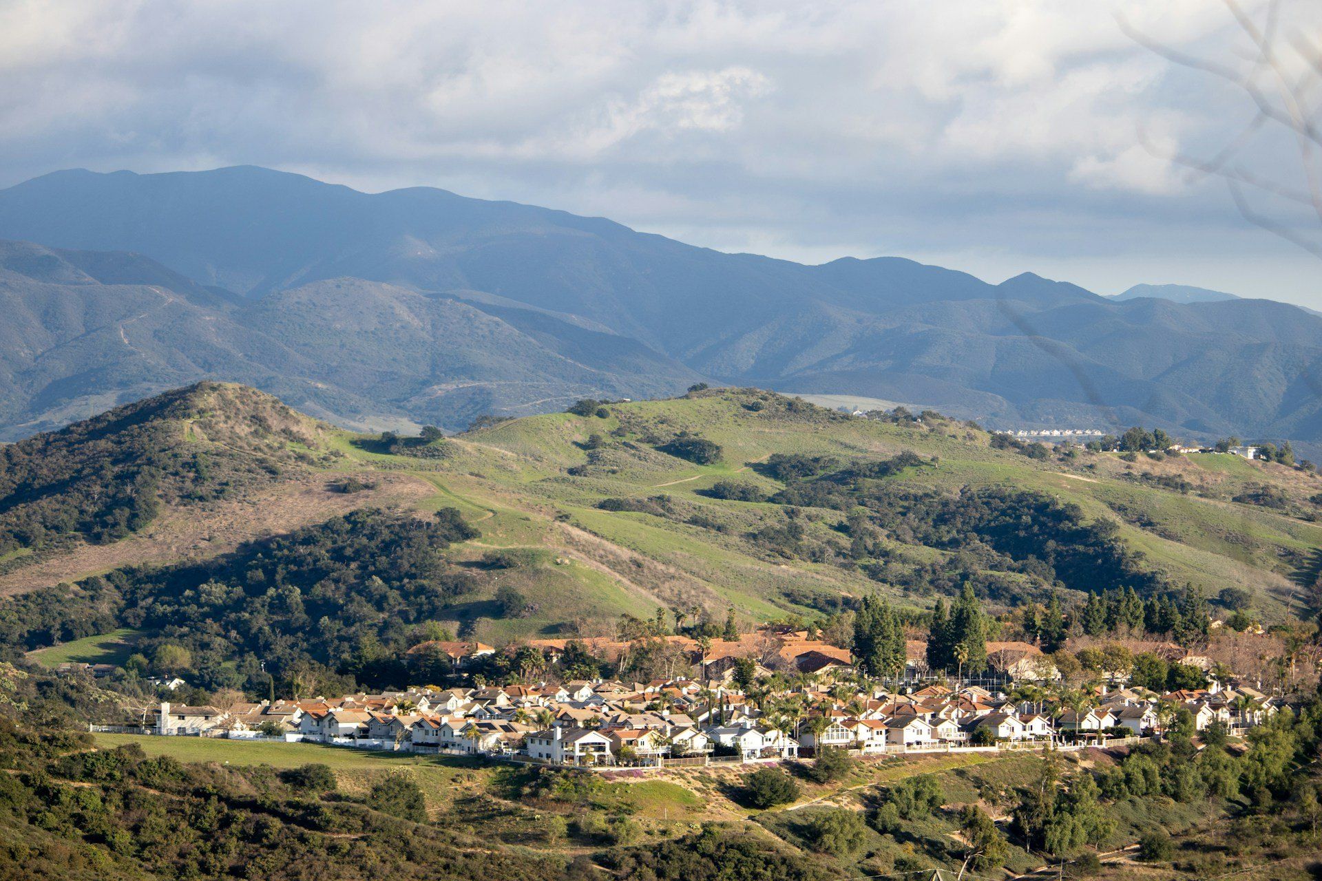 The town of Rancho Santa Margarita in its valley below green hills, California